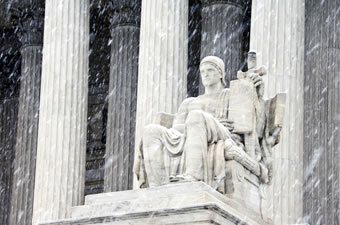 Supreme Court statue in snowfall
